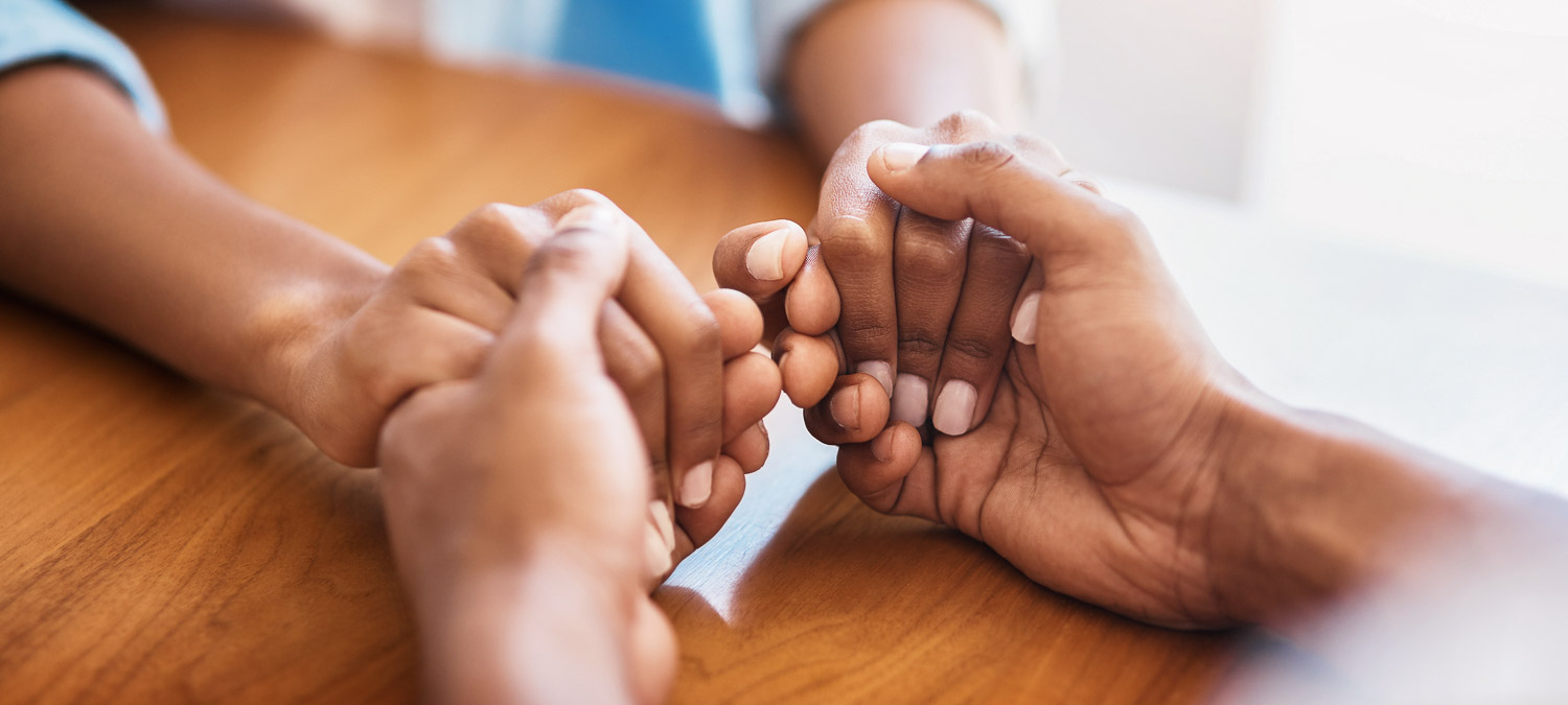 Empathy, faith and trust with friends and holding hands for comfort, kindness and gratitude. Hope, help and support with closeup of people at home for depression during cancer, praying or forgiveness